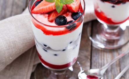 Glass of whipped cream with red fruits