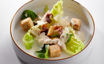 Caesar salad with chicken, parmesan and croutons with a sour taste dressing